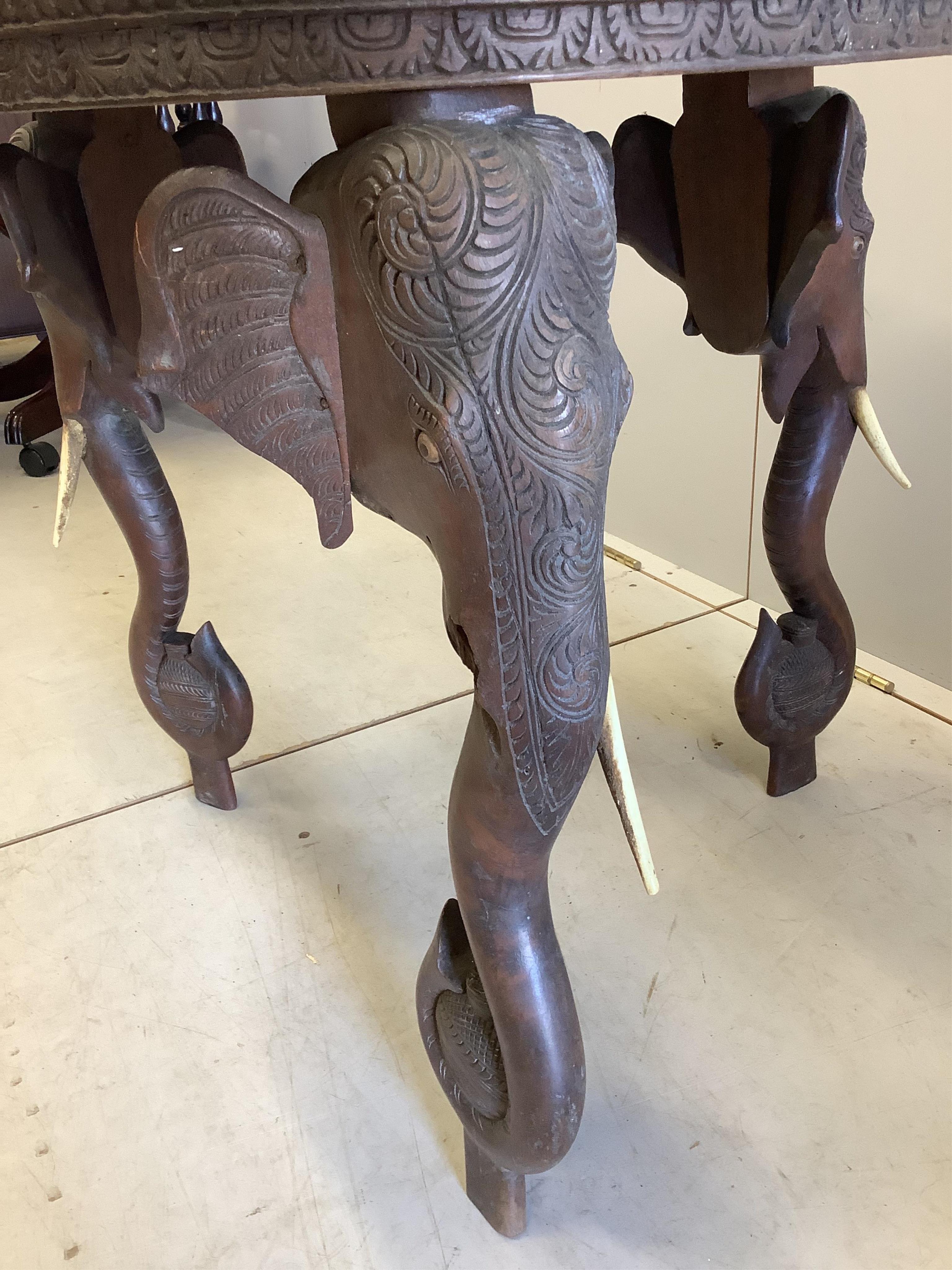 A circular Indian carved hardwood elephant's leg occasional table, diameter 61cm, height 63cm. CITES Submission reference, 8ZTMP59B